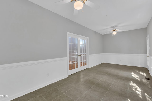 empty room featuring french doors, tile patterned floors, a ceiling fan, and visible vents