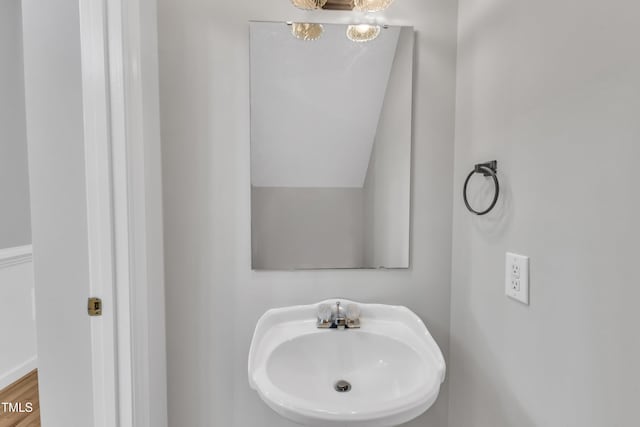 bathroom featuring a sink and a chandelier