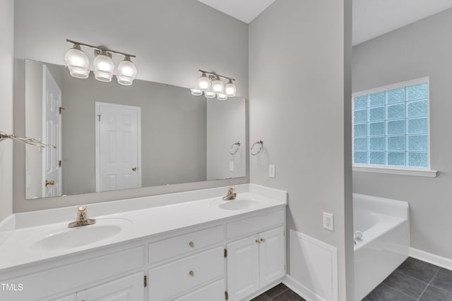 full bathroom featuring double vanity, tile patterned floors, a sink, and a bath