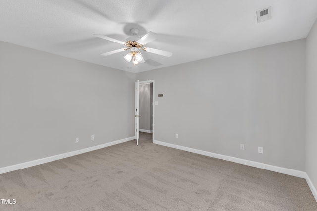 empty room with visible vents, a ceiling fan, baseboards, and carpet floors