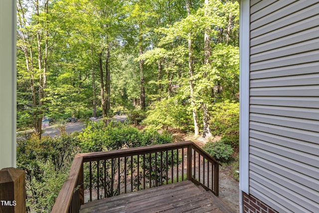 wooden terrace with a view of trees