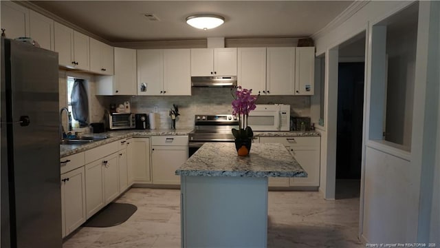 kitchen with stainless steel range with electric stovetop, a sink, white microwave, freestanding refrigerator, and under cabinet range hood