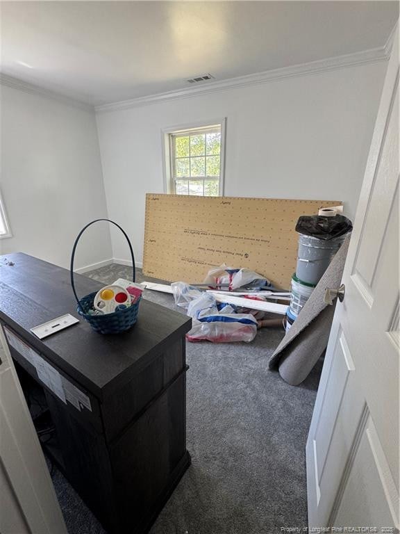misc room featuring carpet floors, visible vents, and ornamental molding