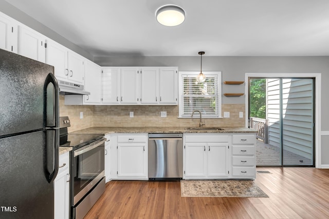 6513 Hearthstone Dr, Raleigh, NC 27615 - kitchen featuring stainless steel appliances, a sink, under cabinet range hood, light wood-style floors, and white cabinetry