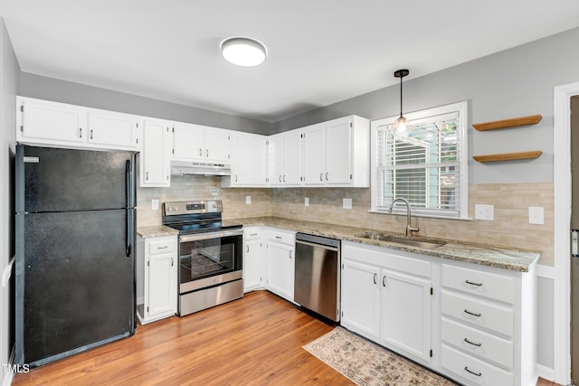 6513 Hearthstone Dr, Raleigh, NC 27615 - kitchen featuring appliances with stainless steel finishes, under cabinet range hood, a sink, and light stone counters