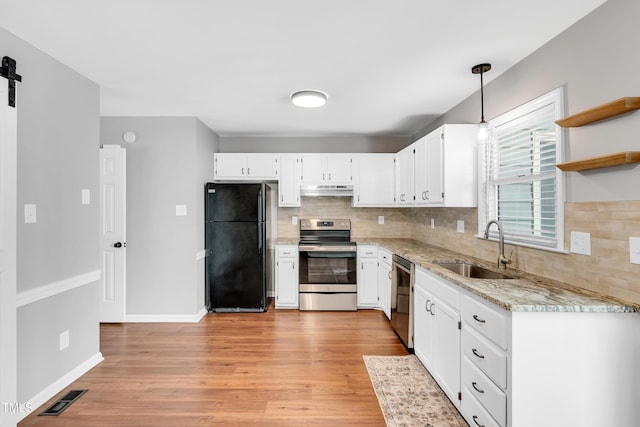 6513 Hearthstone Dr, Raleigh, NC 27615 - kitchen with stainless steel appliances, a sink, under cabinet range hood, tasteful backsplash, and white cabinetry