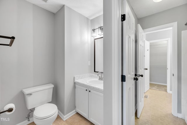 6513 Hearthstone Dr, Raleigh, NC 27615 - bathroom featuring toilet, baseboards, vanity, and tile patterned floors