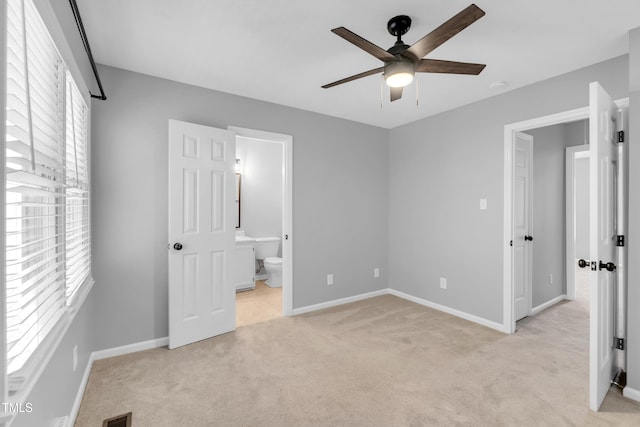 6513 Hearthstone Dr, Raleigh, NC 27615 - unfurnished bedroom featuring multiple windows, light colored carpet, baseboards, and connected bathroom