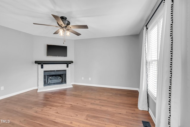 6513 Hearthstone Dr, Raleigh, NC 27615 - unfurnished living room with a brick fireplace, ceiling fan, wood finished floors, and baseboards