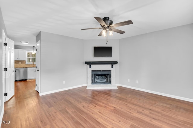 6513 Hearthstone Dr, Raleigh, NC 27615 - unfurnished living room featuring a ceiling fan, light wood-style flooring, a fireplace, and baseboards
