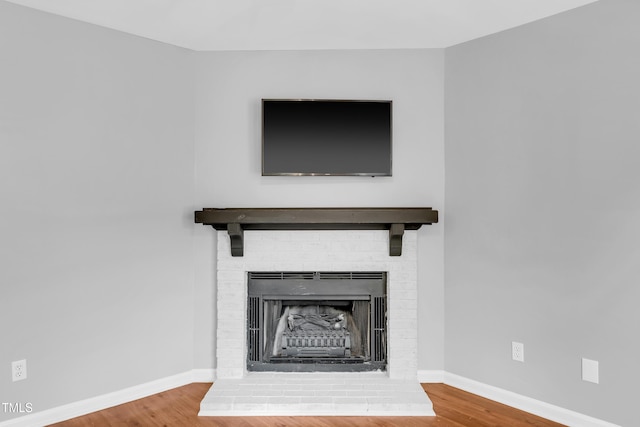 6513 Hearthstone Dr, Raleigh, NC 27615 - detailed view of wood finished floors, a fireplace, and baseboards