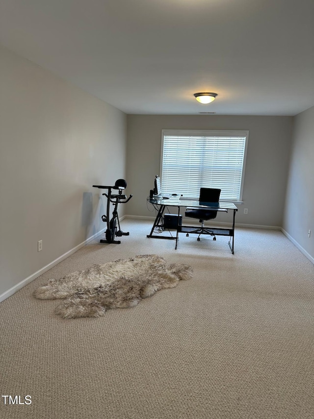 carpeted office featuring baseboards