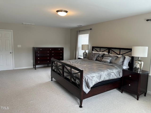 carpeted bedroom with baseboards and visible vents