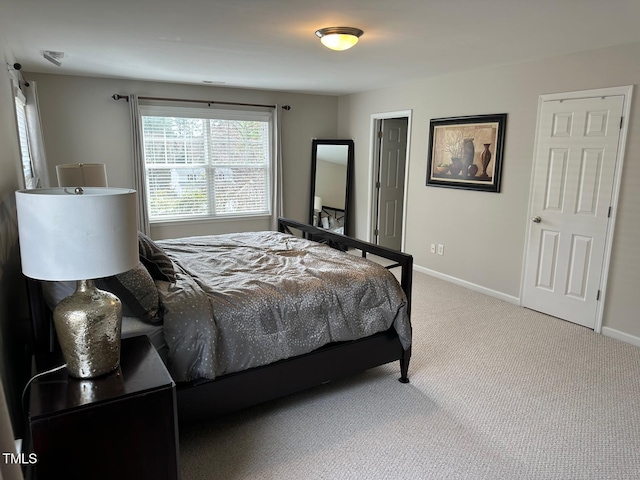 bedroom featuring baseboards and carpet
