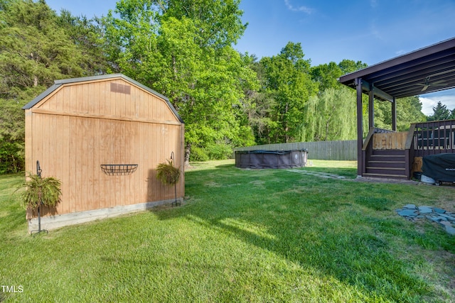 view of yard featuring a fenced in pool, an outdoor structure, and a deck