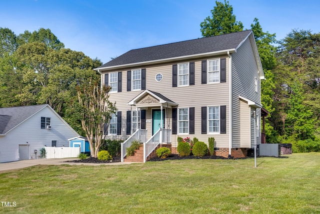 colonial home with fence and a front yard