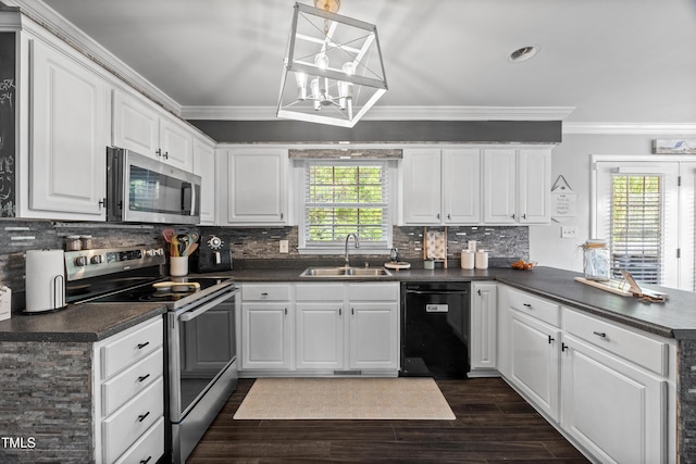 kitchen with a sink, appliances with stainless steel finishes, dark countertops, and ornamental molding