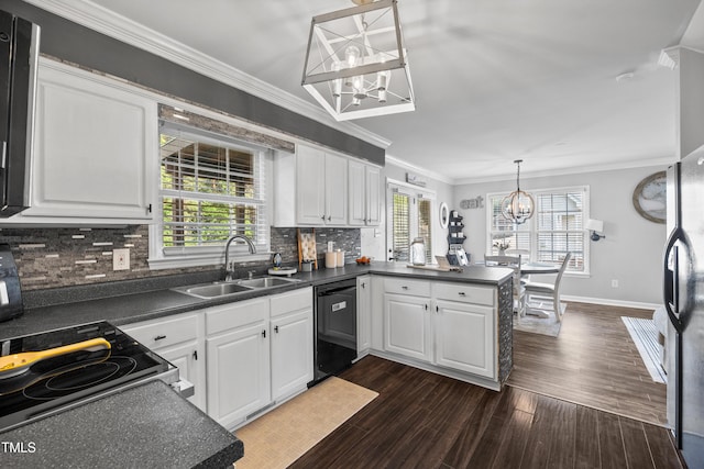 kitchen with a sink, dark countertops, black appliances, and a chandelier