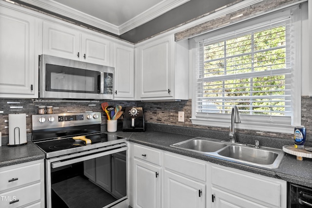 kitchen with ornamental molding, white cabinetry, a sink, backsplash, and stainless steel appliances