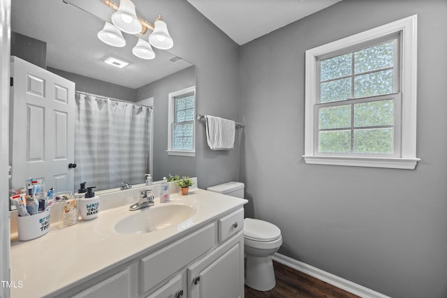 full bathroom featuring curtained shower, wood finished floors, baseboards, vanity, and toilet