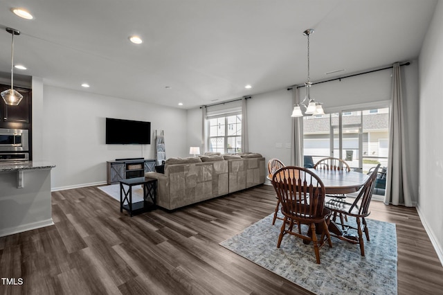 dining room with recessed lighting, dark wood-type flooring, and baseboards