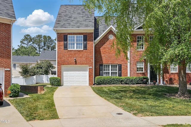 view of front facade featuring driveway, brick siding, a front yard, and an attached garage