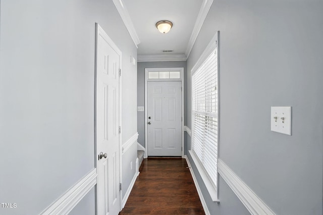 doorway to outside featuring crown molding and dark wood-style flooring