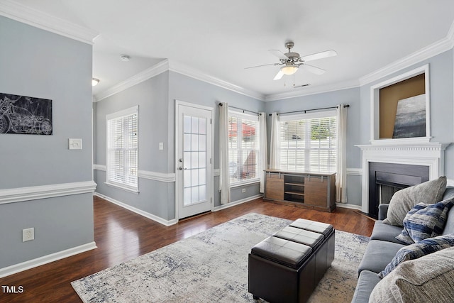 living room featuring a fireplace, baseboards, a ceiling fan, and wood finished floors