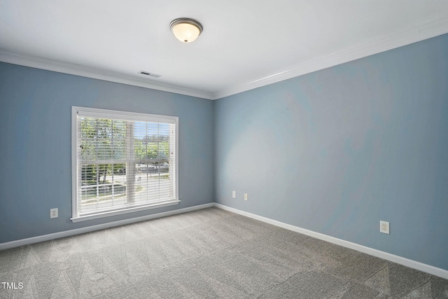 carpeted empty room featuring ornamental molding, baseboards, and visible vents