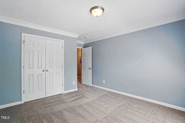 unfurnished bedroom featuring baseboards, a closet, crown molding, and carpet