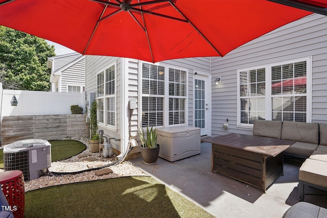 view of patio featuring fence, an outdoor hangout area, and central AC