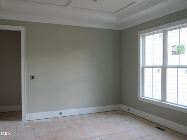 spare room featuring baseboards and visible vents