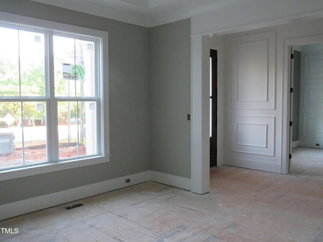 empty room with baseboards and visible vents