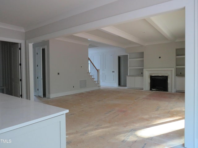 unfurnished living room featuring a fireplace, built in shelves, stairs, beamed ceiling, and visible vents