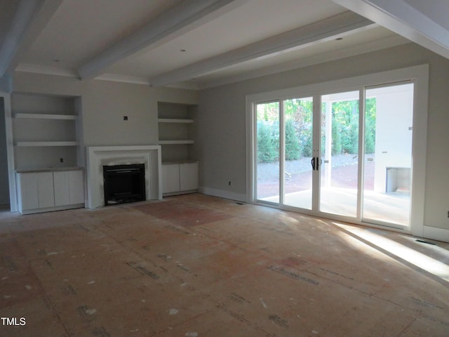 unfurnished living room featuring beamed ceiling, built in features, and a fireplace