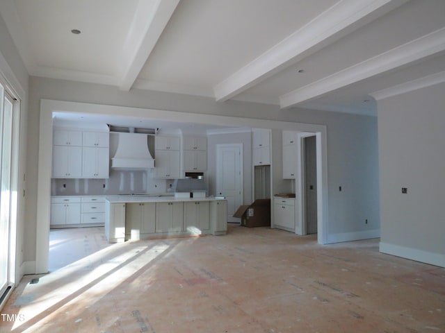 unfurnished living room with beamed ceiling