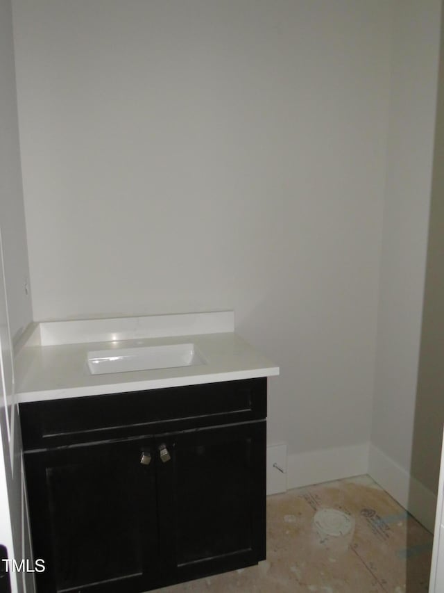 bathroom with vanity and baseboards