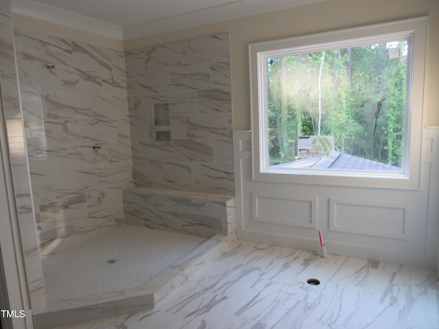 full bathroom with tiled shower and marble finish floor