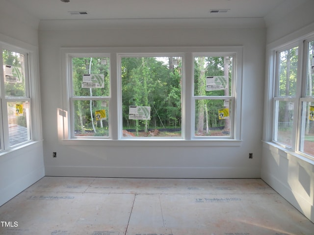 unfurnished sunroom with visible vents and a healthy amount of sunlight