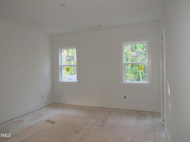 spare room featuring baseboards