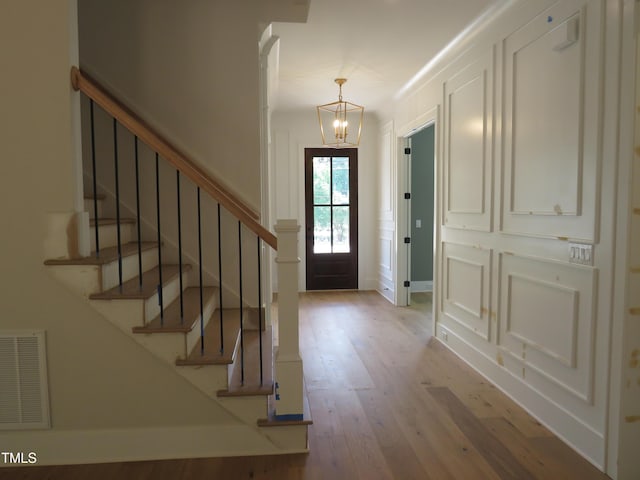 1444 Old Apex Rd, Cary, NC 27513 - entrance foyer featuring a chandelier, wood finished floors, stairway, and baseboards