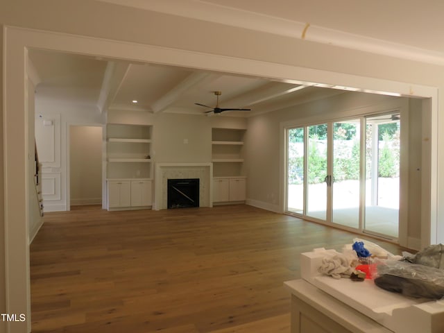 1444 Old Apex Rd, Cary, NC 27513 - unfurnished living room featuring beam ceiling, light wood-style flooring, a ceiling fan, a fireplace, and baseboards