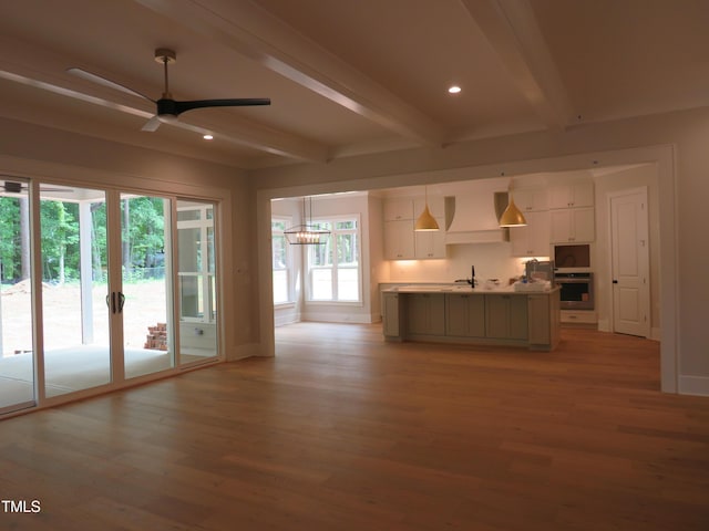 1444 Old Apex Rd, Cary, NC 27513 - unfurnished living room with beamed ceiling, light wood-style flooring, recessed lighting, a ceiling fan, and baseboards