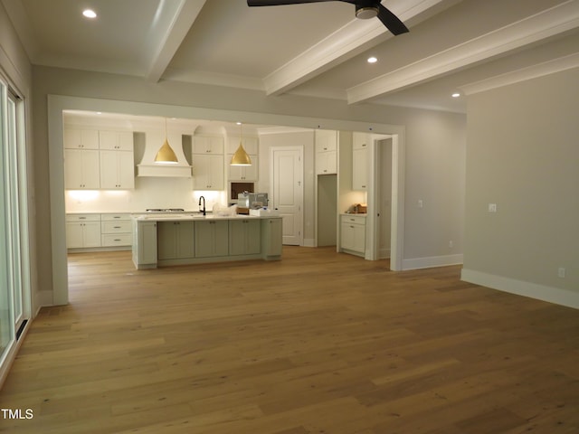 1444 Old Apex Rd, Cary, NC 27513 - kitchen with custom exhaust hood, beamed ceiling, recessed lighting, white cabinets, and light wood-style floors