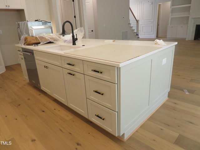 1444 Old Apex Rd, Cary, NC 27513 - kitchen featuring light wood-style floors, a sink, and an island with sink