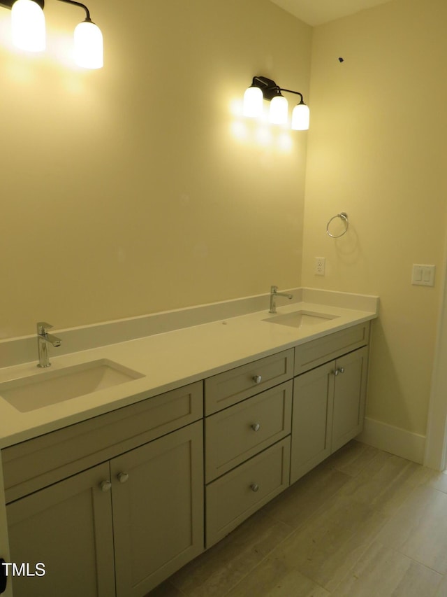 1444 Old Apex Rd, Cary, NC 27513 - bathroom featuring a sink, wood finished floors, and baseboards