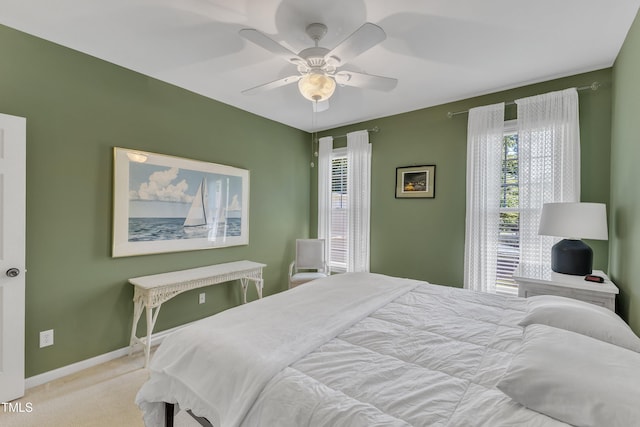 bedroom featuring carpet, baseboards, and a ceiling fan