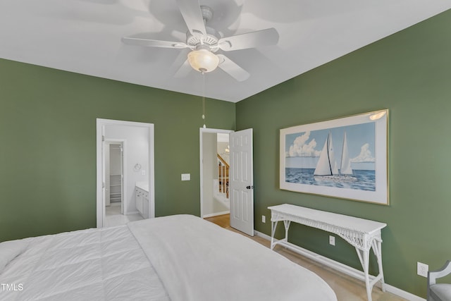 bedroom featuring connected bathroom, baseboards, and ceiling fan