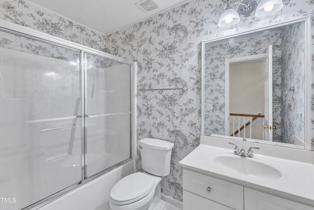 bathroom with vanity, wallpapered walls, toilet, and combined bath / shower with glass door