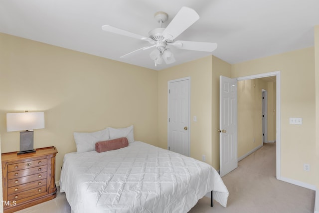 bedroom featuring light carpet, ceiling fan, and baseboards